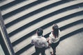 Businessman and Business woman go up the stairs Success concept