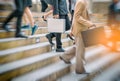 Businessman and Business woman up the stairs in a rush hour to w