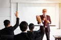 Businessman and business women raises his hand to ask a question to the meeting Royalty Free Stock Photo