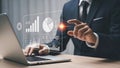 Businessman analyzing financial data on laptop with futuristic interface Royalty Free Stock Photo