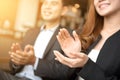 Businessman and businesswoman clapping hands