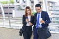 Businessman Businesswoman drinking coffee in town using smartphone outside office modern city. Hands holding take away coffee cup Royalty Free Stock Photo