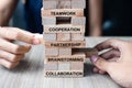 Businessman and Businesswoman hand placing or pulling wooden block on the tower building. Business, Teamwork, Brainstorming, Royalty Free Stock Photo