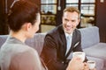 Businessman and businesswoman having tea during breaktime