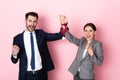 Businessman and businesswoman holding golden medal and gesturing on pink, gender equality concept