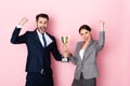 Businessman and businesswoman holding trophy and gesturing on pink, gender equality concept