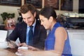 Businessman And Businesswoman Meeting In Coffee Shop