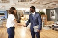 Businessman And Businesswoman Meeting And Shaking Hands In Modern Open Plan Office Royalty Free Stock Photo