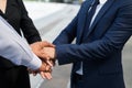 Businessman and businesswoman shaking hands for demonstrating their agreement to sign agreement or contract between their company