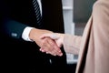 Businessman and businesswoman shaking hands after meeting, businesspeople reached agreement on negotiation deal, successful unity Royalty Free Stock Photo