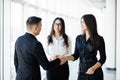 Businessman And businesswoman shaking hands In bright Office Royalty Free Stock Photo