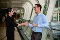 Businessman and businesswoman shaking hands for success agreement and talk about business