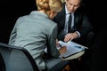 Businessman and businesswoman signing papers together Royalty Free Stock Photo