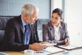 Businessman and businesswoman sitting in conference room Royalty Free Stock Photo