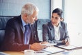 Businessman and businesswoman sitting in conference room Royalty Free Stock Photo