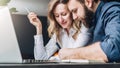 Businessman and businesswoman are sitting at table in front of laptop, discussing business concept. Man is writing pen Royalty Free Stock Photo