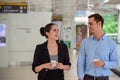 Businessman and businesswoman stand and laughing, talk about business with Plastic Mug on hand