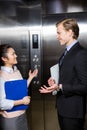 Businessman and businesswoman standing in an elevator Royalty Free Stock Photo