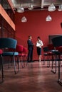 Businessman and businesswoman standing near dashbord during presentation