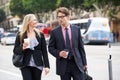 Businessman And Businesswoman In Street With Takeaway Coffee Royalty Free Stock Photo