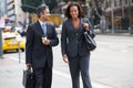 Businessman And Businesswoman In Street With Takeaway Coffee