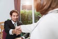 Businessman and businesswoman suit smiling handshake