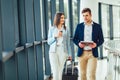 Businessman and businesswoman talking smiling and hold luggage travel to business trip Royalty Free Stock Photo