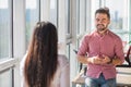 Businessman and businesswoman talking in office interior