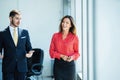 Businessman and businesswoman talking while walking in modern office Royalty Free Stock Photo