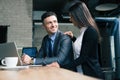 Businessman and businesswoman using laptop in cafe Royalty Free Stock Photo