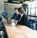 Businessman and businesswoman using laptop in cafe Royalty Free Stock Photo