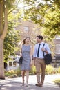 Businessman And Businesswoman Walk to Work Through City Park Royalty Free Stock Photo