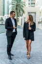 Businessman and Businesswoman walking along street have informal meeting Royalty Free Stock Photo