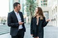 Businessman and Businesswoman walking along street have informal meeting Royalty Free Stock Photo