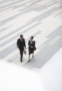 Businessman And Businesswoman Walking In Outdoor Plaza Royalty Free Stock Photo