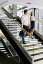Businessman and businesswoman walking and taking stairs Royalty Free Stock Photo