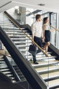 Businessman and businesswoman walking and taking stairs Royalty Free Stock Photo