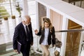 Businessman and businesswoman walking and taking stairs in an of Royalty Free Stock Photo