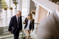 Businessman and businesswoman walking and taking stairs in an of Royalty Free Stock Photo