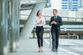 Businessman and businesswoman walking and talking on street in city Outside Office with ,young couple discussing and eating