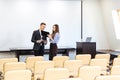 Businessman and businesswoman working in meeting hall Royalty Free Stock Photo