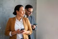 Businessman and businesswoman working and using smart mobile phones on meeting in corporate office Royalty Free Stock Photo