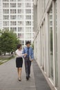 Businessman and businesswomen walking outside of CBD, pointing in Royalty Free Stock Photo