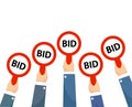 Businessman buyers hands raising auction bid paddles with numbers of competitive bidding price. Auction business bidders raise