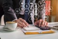 Businessman calculates financials with graph paper on the laptop the cost of home office. Royalty Free Stock Photo