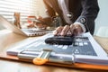 Businessman calculates financials with graph paper on the table on the cost of home office. Royalty Free Stock Photo