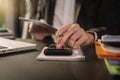 Businessman calculates financials with graph paper on the table on the cost of home office. Royalty Free Stock Photo