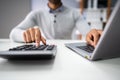 Businessman Calculating Expense In Office Royalty Free Stock Photo