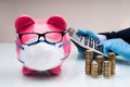 Businessman Calculating Invoice With Piggybank And Coins At Desk Royalty Free Stock Photo