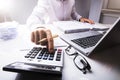 Businessman Calculating Tax Using Calculator